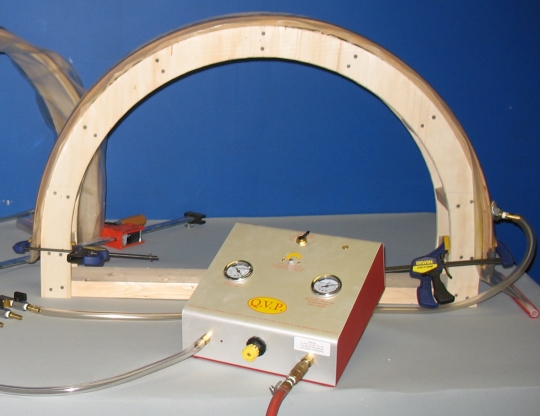 glued up bent laminations in vacuum bag being put on form